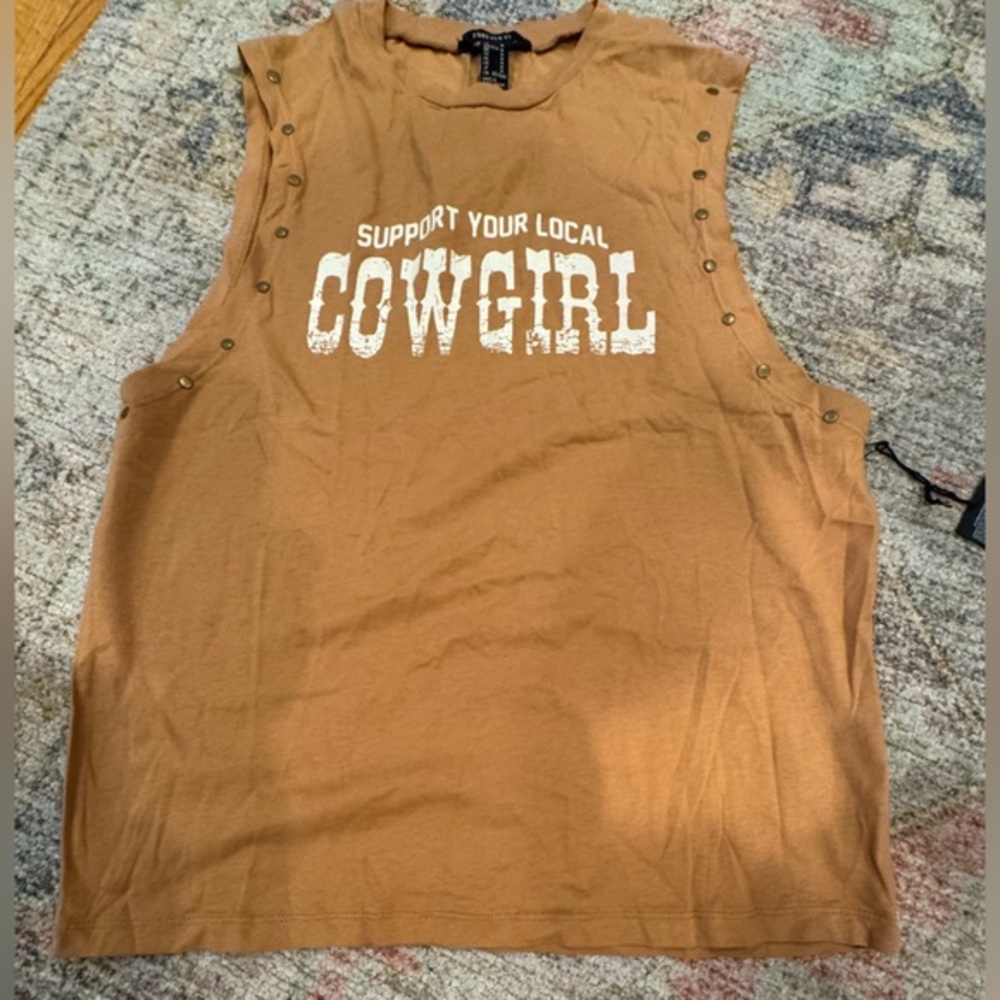 Brown Sleeveless “support your local Cowgirl “ Top with unique finish and brads!
